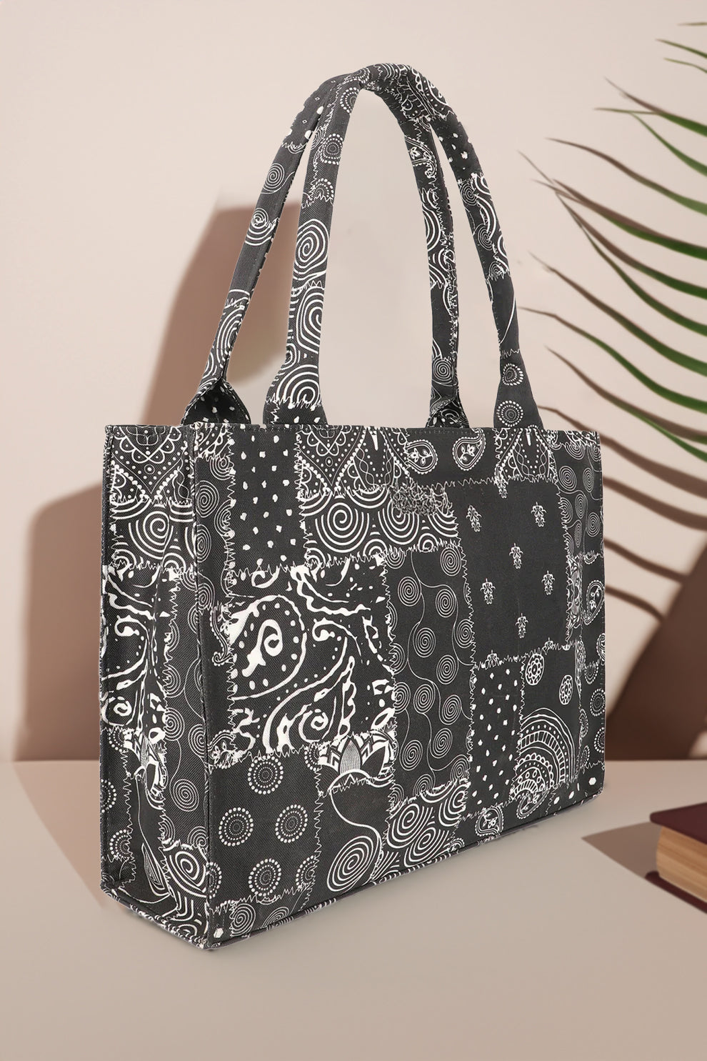 Black and white patterned tote bag on a beige background