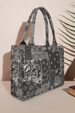 Black and white patterned tote bag on a beige background