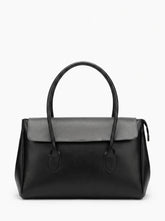 A black leather handbag with a structured rectangular shape, dual top handles, and a flap closure, shown against a plain white background.