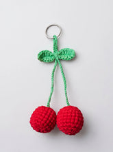 Close-up of handmade crochet cherry keychain showing stuffed red spheres and green leaf detail - WestStyle Pakistan
