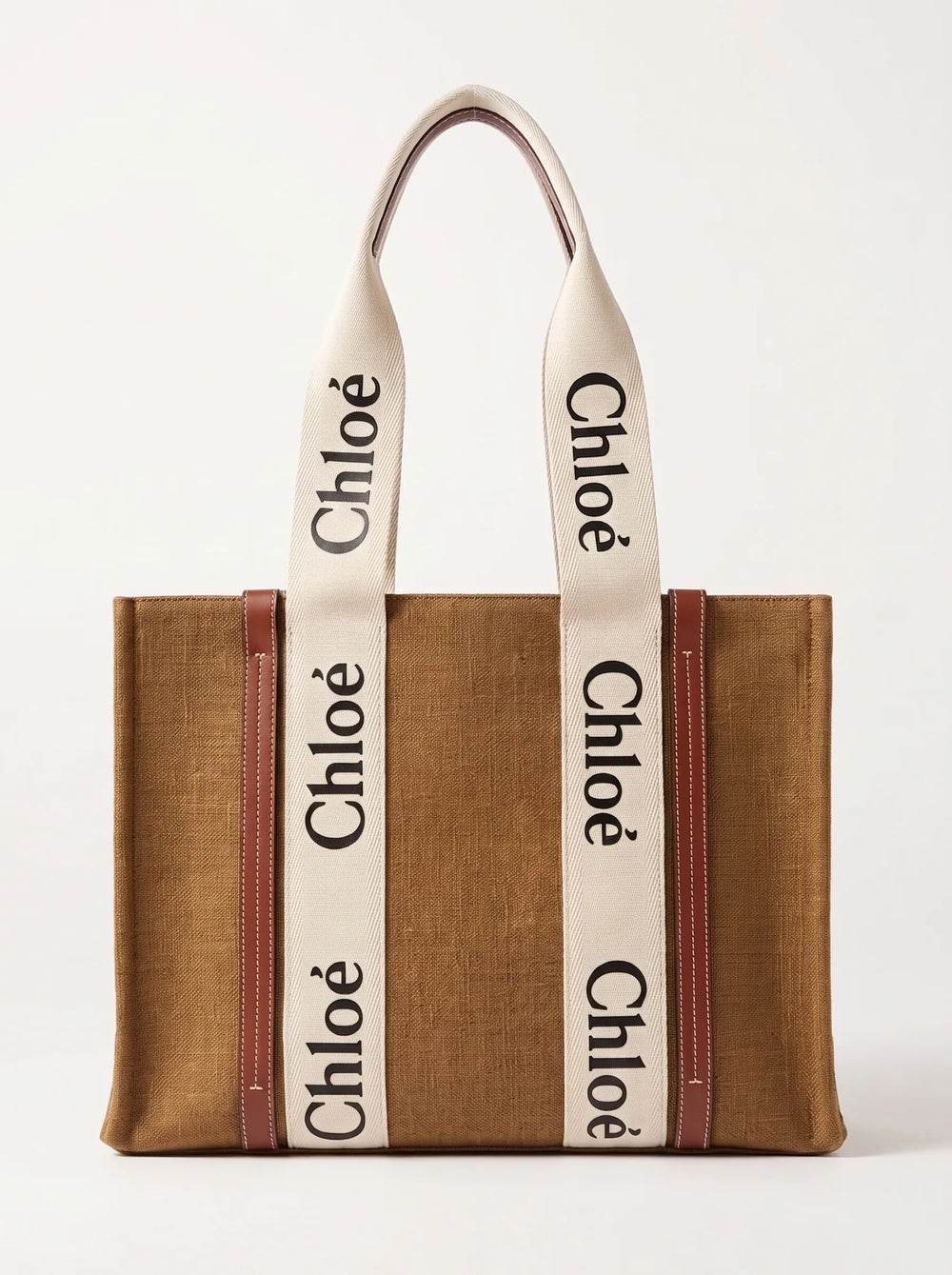 A brown woven tote bag with cream-colored shoulder straps featuring the black 'Chloé' logo repeated vertically, and brown leather trim on the sides.