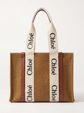 A brown woven tote bag with cream-colored shoulder straps featuring the black 'Chloé' logo repeated vertically, and brown leather trim on the sides.