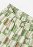 Green and white checkered shorts with pink bows and white hearts on a white background