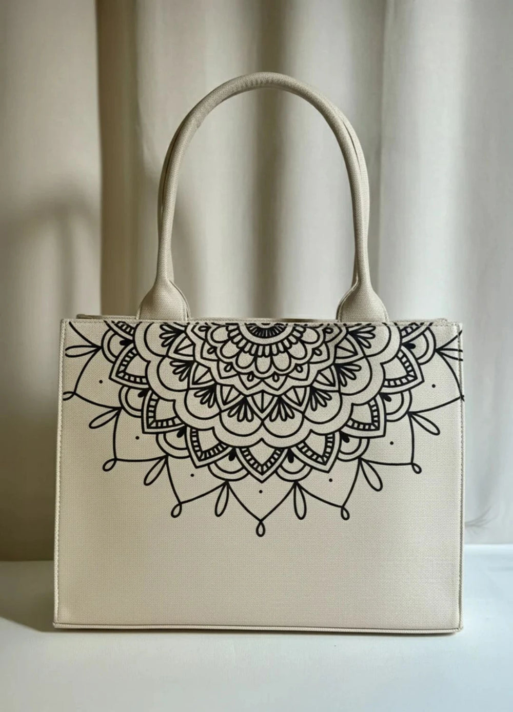 Women Beige handbag with black mandala design on a neutral background