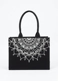 Black tote bag with white mandala design on a white background