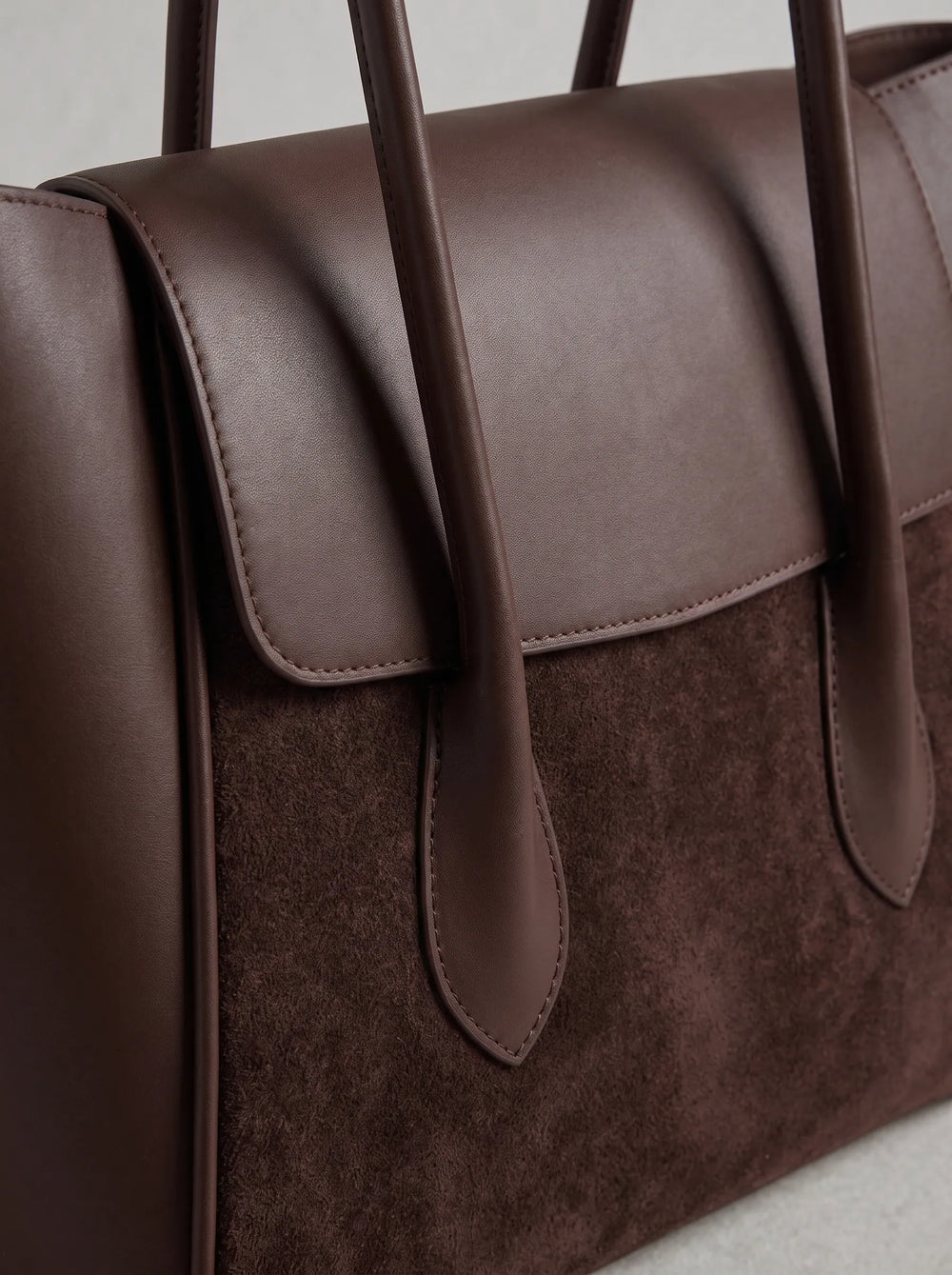 Close-up of dual-texture contrast between smooth leather and suede panel on WestStyle Pyraflip brown tote — designer women bag Pakistan