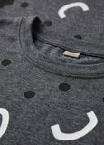Gray t-shirt with smiley face design and visible brand label.