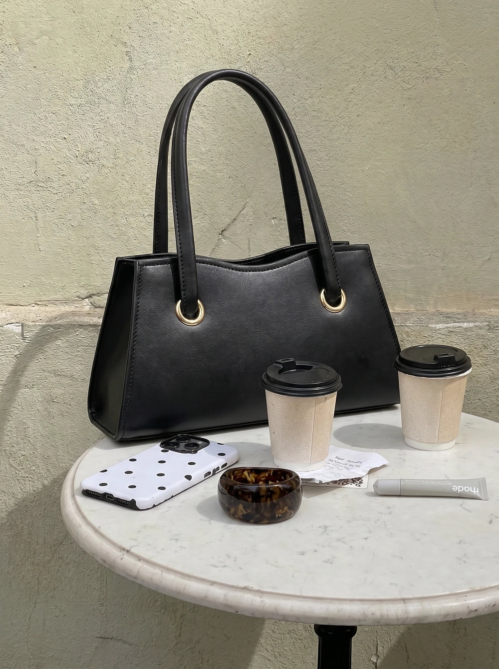 WestStyle Baul Ring black crossbody bag with gold O-ring handles on café table trendy crossbody bag for girls Pakistan