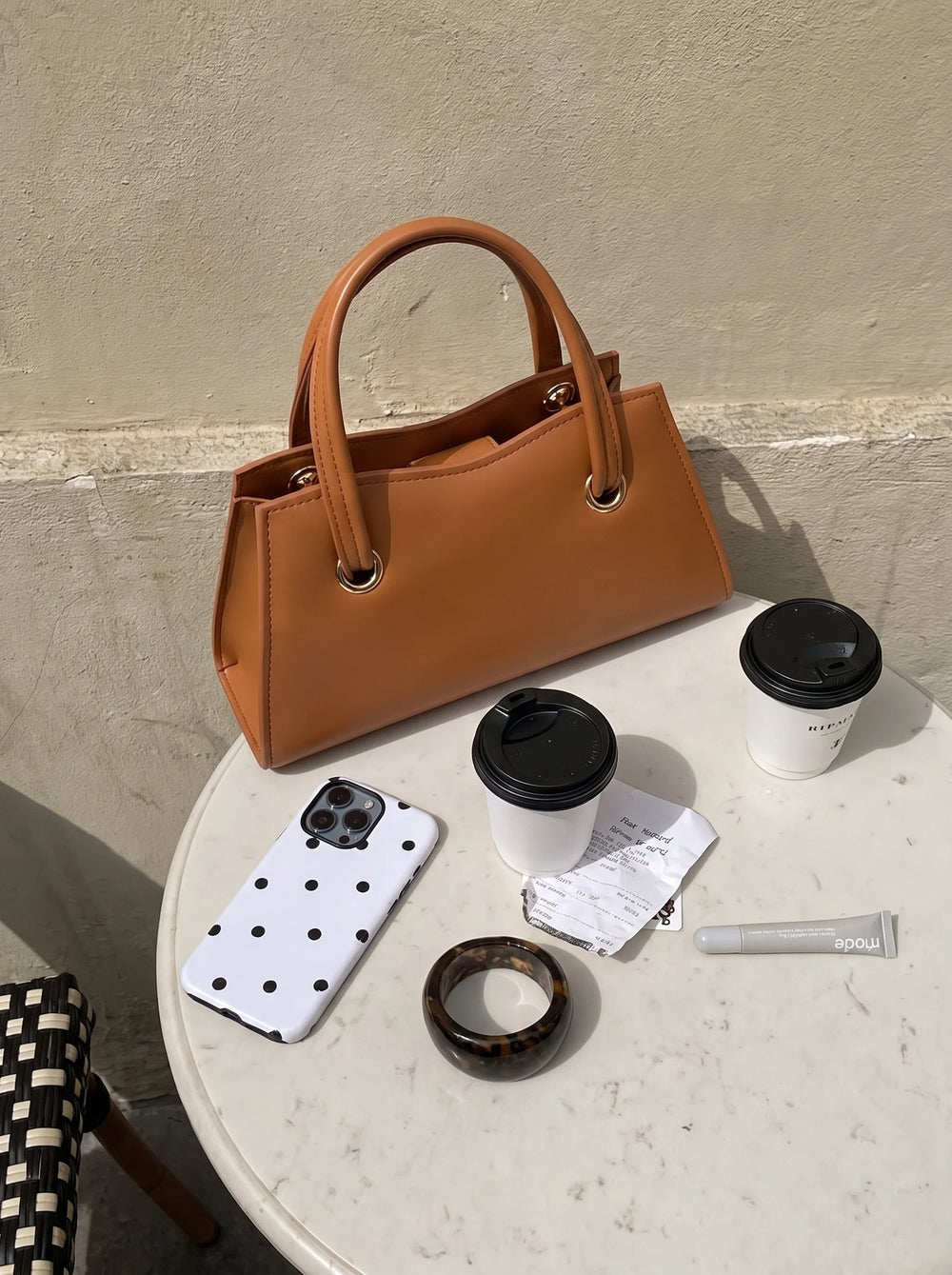 Front view of the WestStyle Baul Ring small crossbody bag in mustard PU leather with gold tone ring details