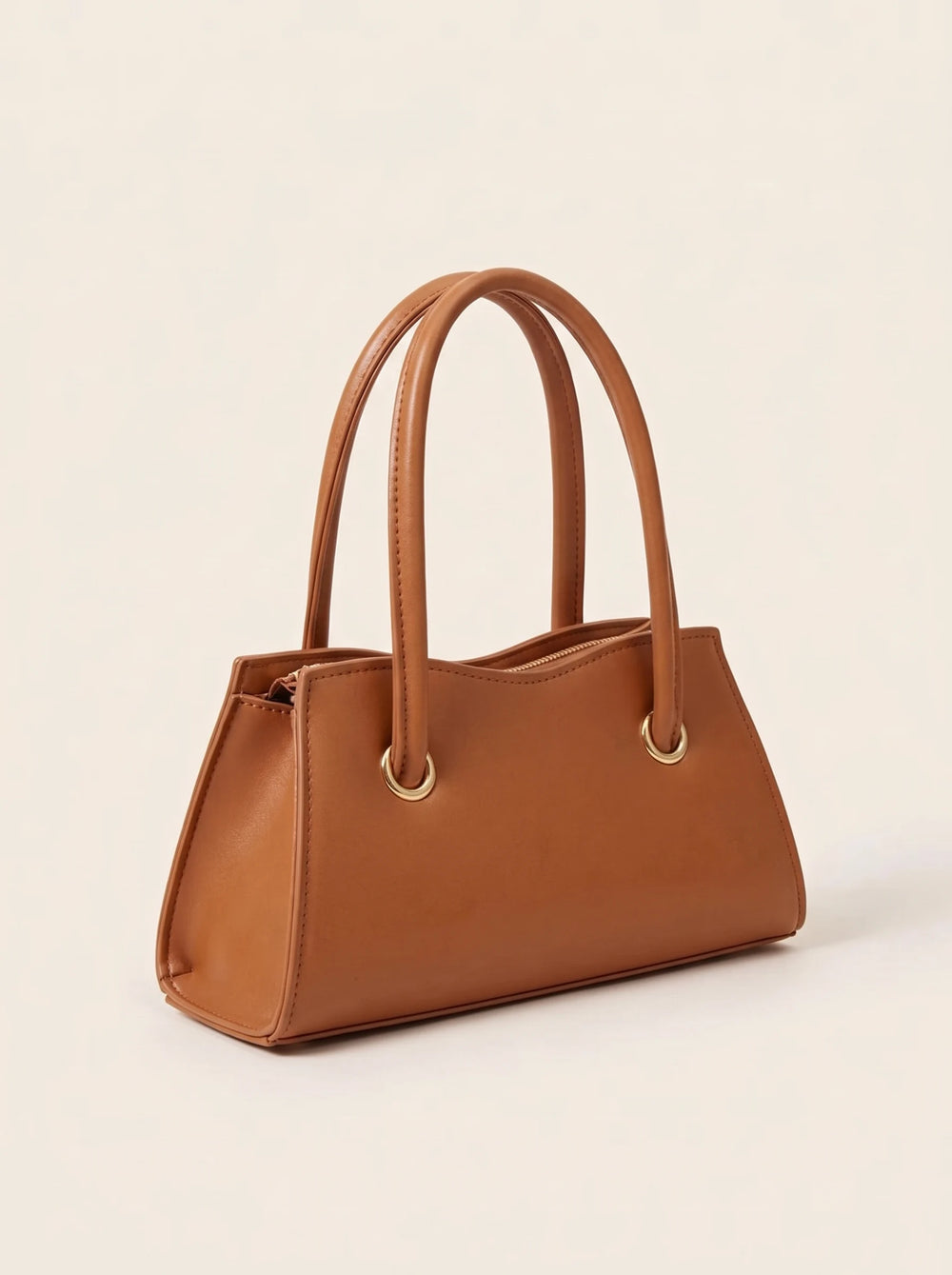 Side view of the structured PU leather crossbody bag showing its 2 inch depth