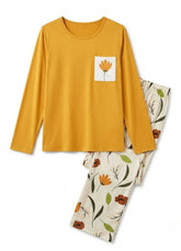 Yellow long-sleeve top with a flower pocket and floral-patterned pants on a white background