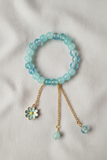 Professional flat lay of aqua bracelet on linen