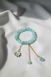 Professional jewelry photography of aqua bracelet on white silk