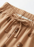 Brown shorts with bear prints and a drawstring on a light background