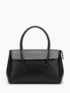A black leather handbag with a structured rectangular shape, dual top handles, and a flap closure, shown against a plain white background.
