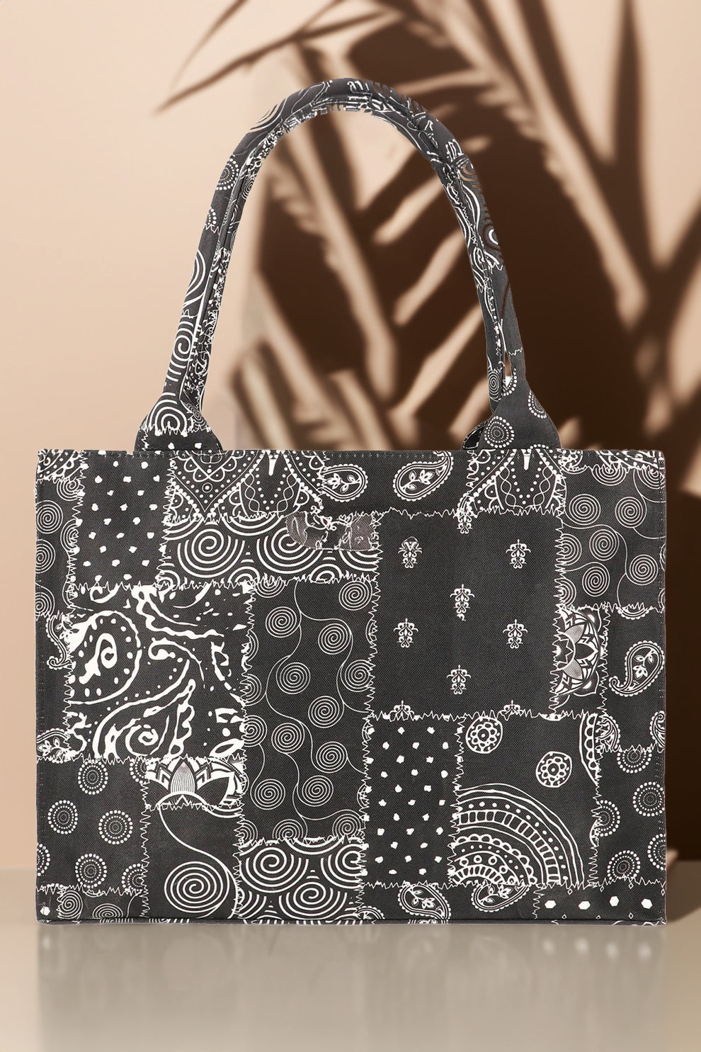 Black and white patterned tote bag on a beige background