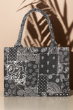 Black and white patterned tote bag on a beige background