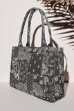 Black tote bag with white patterns on a light gray background