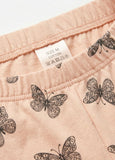 Butterfly patterned fabric with a size label on a pink background
