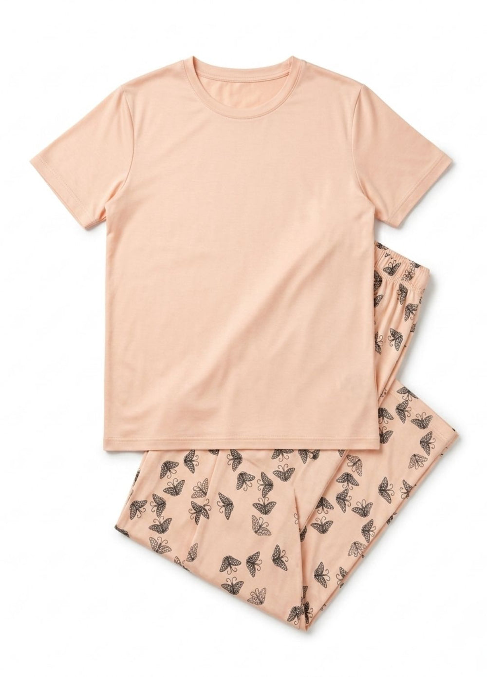 Pink pajama set with short-sleeve top and patterned pants on a white background