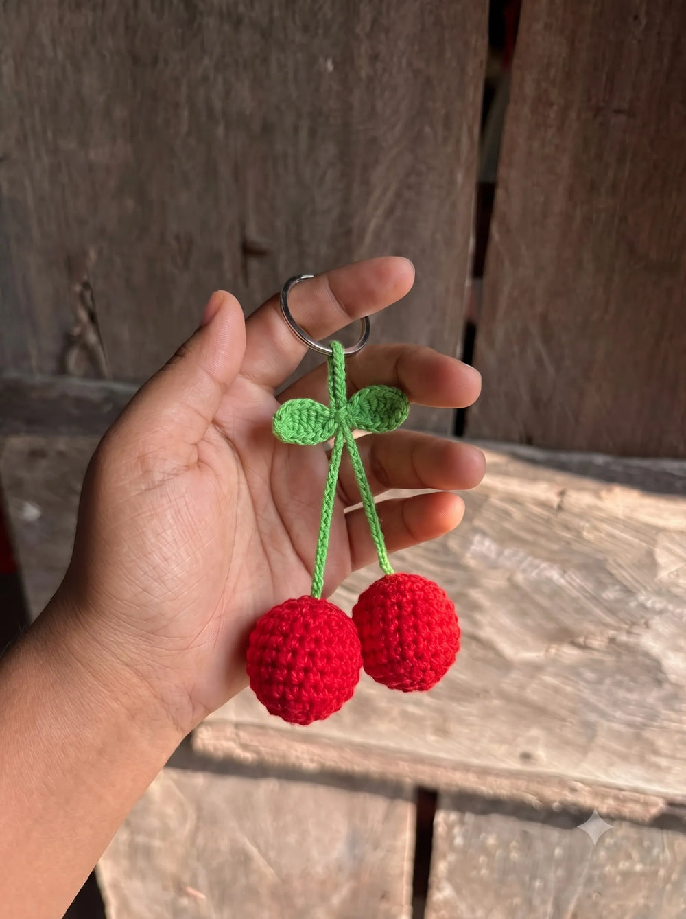 Handmade crochet cherry keychain with two red spheres, green stems and leaves - cute bag charm for girls by WestStyle Pakistan