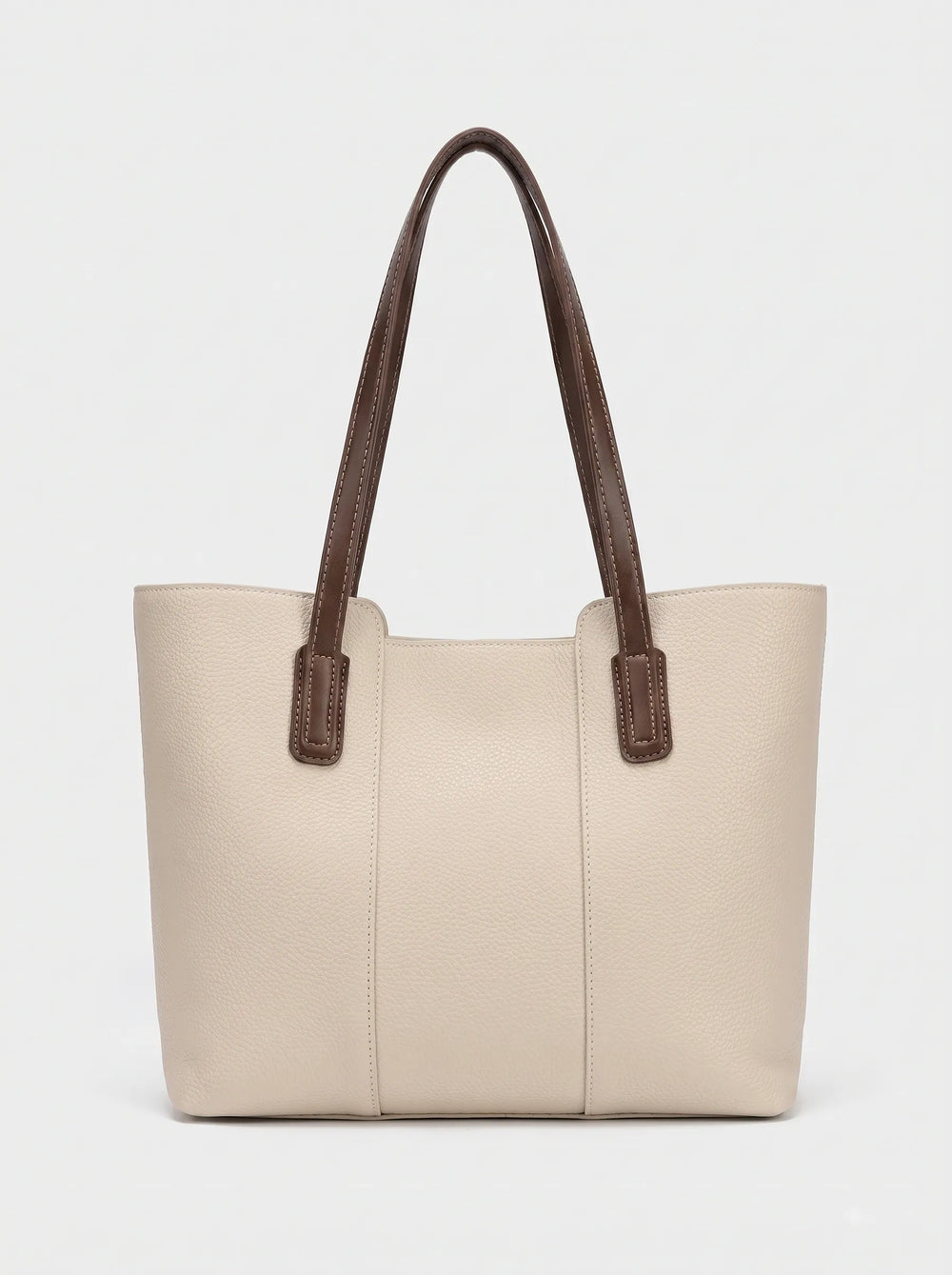 WestStyle cream leather tote bag three-quarter view showing trapezoid silhouette and brown handle tabs ladies tote bag Pakistan