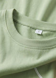 Close-up of a green shirt with a brand label on the collar.