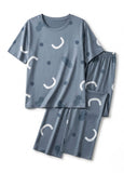 Blue pajama set with white crescent moon patterns on a white background