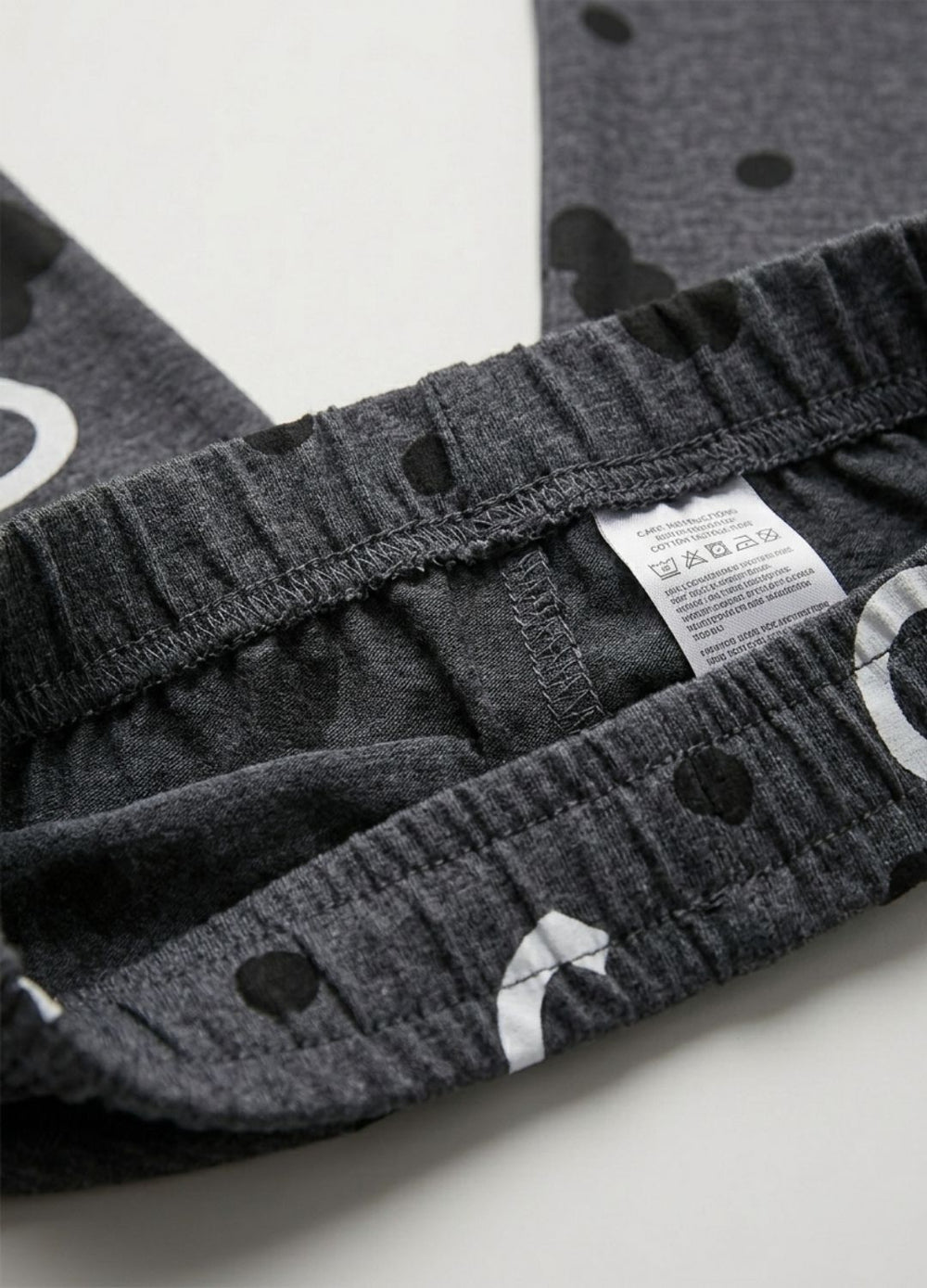 Close-up of gray Pajama with a weststyle label on a white background