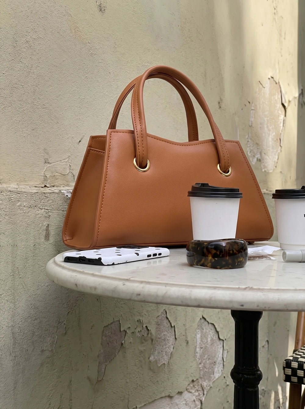 Close up of gold tone ring joining the top handle on a WestStyle women's crossbody bag