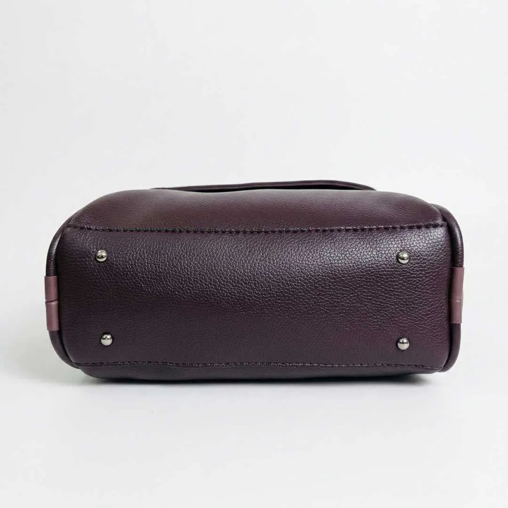 Brown leather bag with silver studs on a white background