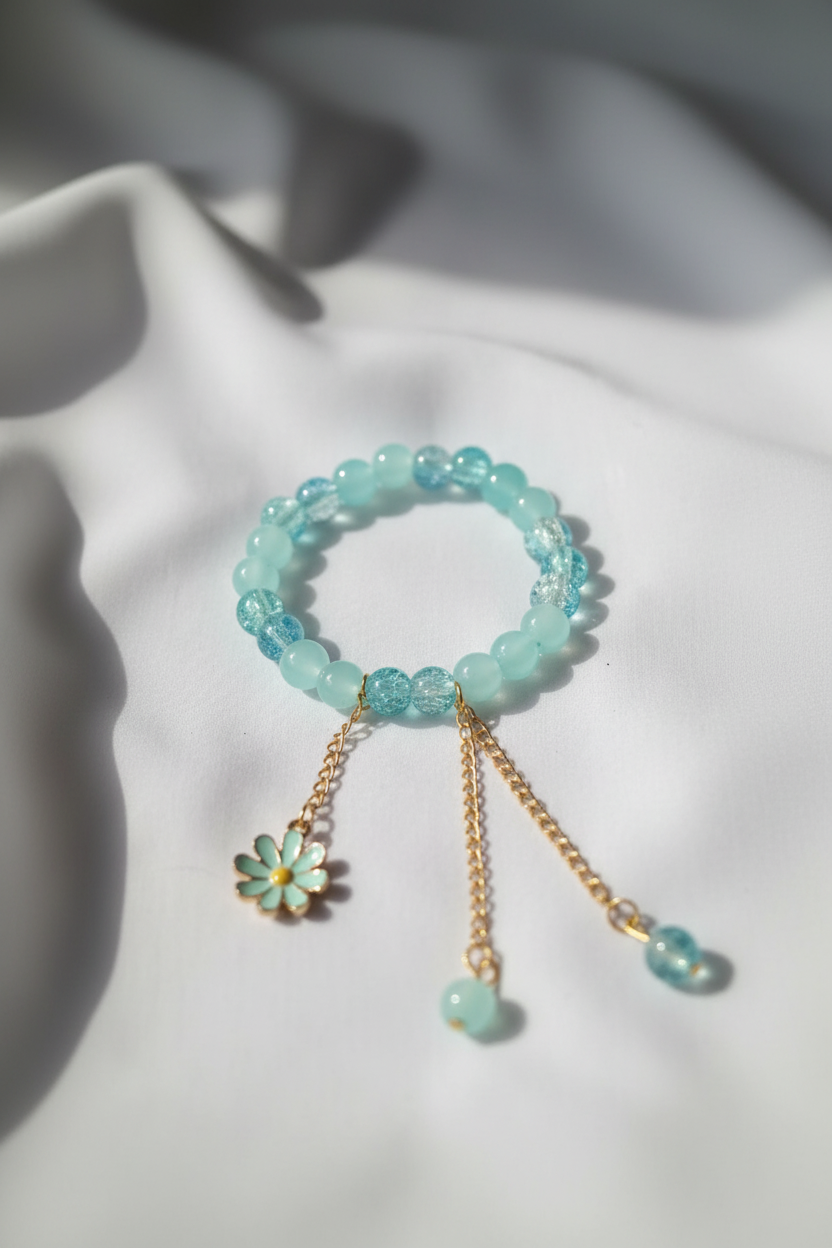 Professional jewelry photography of aqua bracelet on white silk