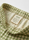 Close-up of a green patterned fabric with a Jumi label on a white background